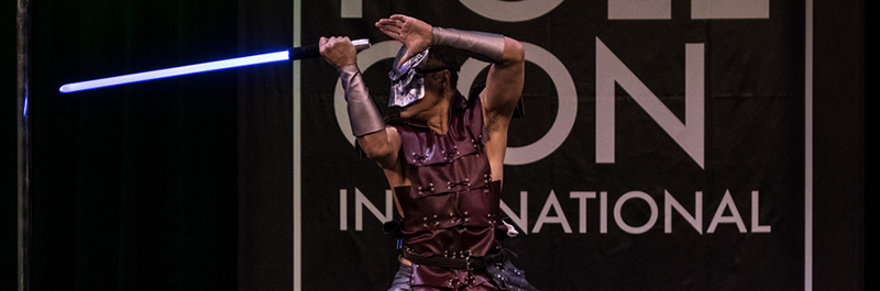 Performer Dances On Stage In Mask.