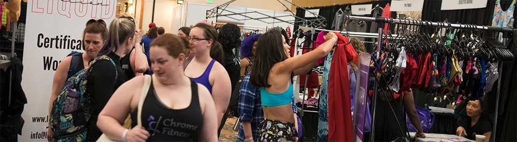 Shoppers at an apparel booth at PoleCon.