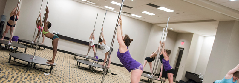 Students Stretching On Portable Dance Poles.