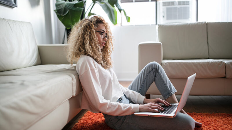 Person On Laptop In Apartment.