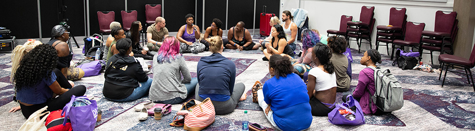 Students gather around workshop instructor.