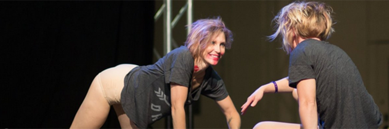 Performers Doing Floor Work On Stage.