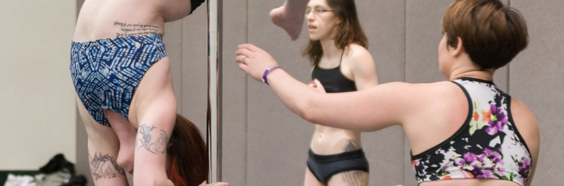 Pole Dance Instructor Provides Instruction To An Inverted Student.