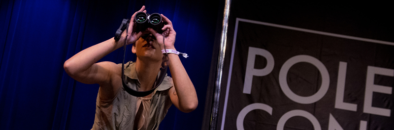 Performer With Binoculars At PoleCon.