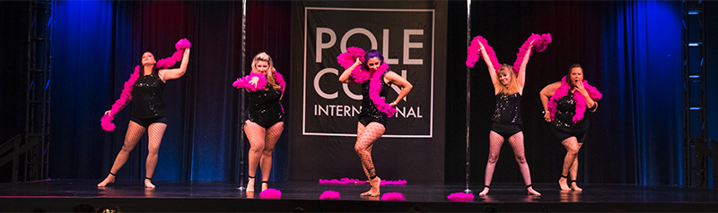 Pole Troupe Performs On Stage At PoleCon.