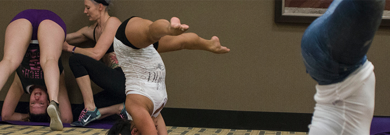 Instructor Assists Students With Handstands.