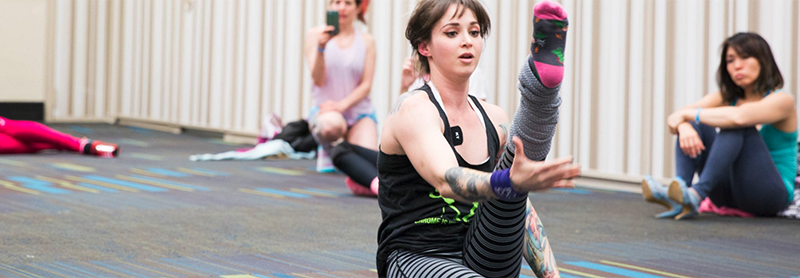 Instructor Demonstrates Stretching For Students.