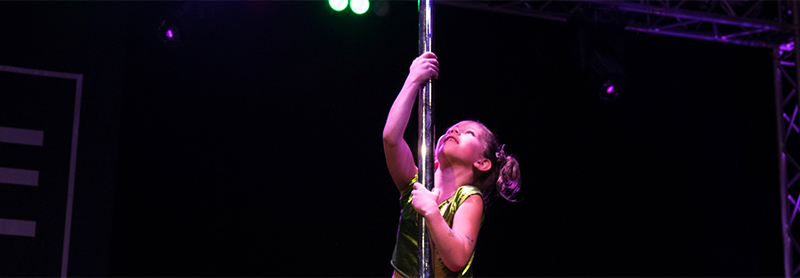 Child Dancer Climbing A Pole On Stage.