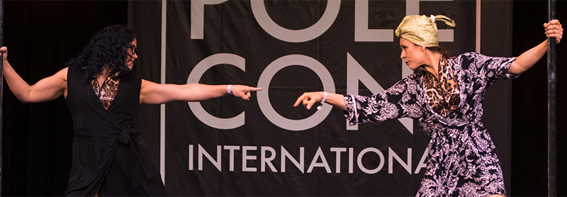 Two Female Performers (the Dirty South Pole Squad) Perfom On The PoleCon Stage.