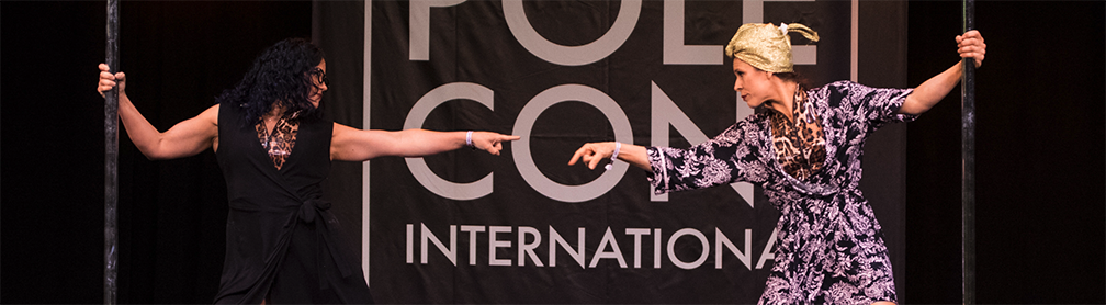 Two female performers (the Dirty South Pole Squad) perfom on the PoleCon Stage.