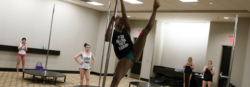 Pole Class, Instructor Demoing Pole Dance Move.