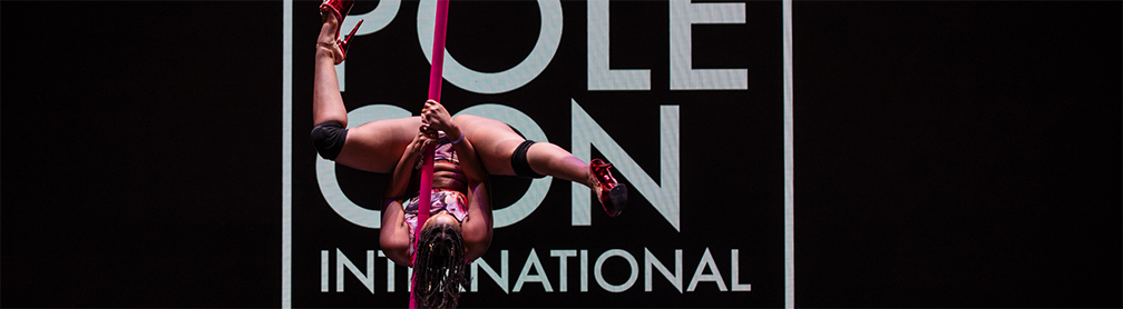 Pink Quartz performs on a flying pole at PoleCon 2024