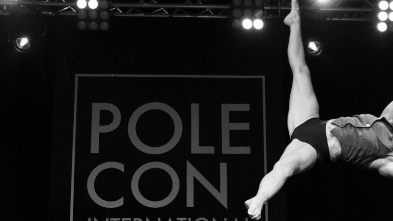 Fran performs an Iron X pole move during PoleCon 2022