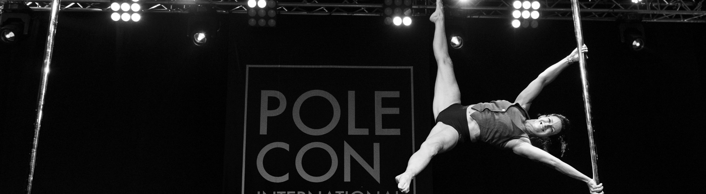 Fran performs an Iron X pole move during PoleCon 2022